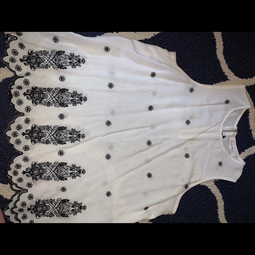 Cute dressy tank with black embroidery.